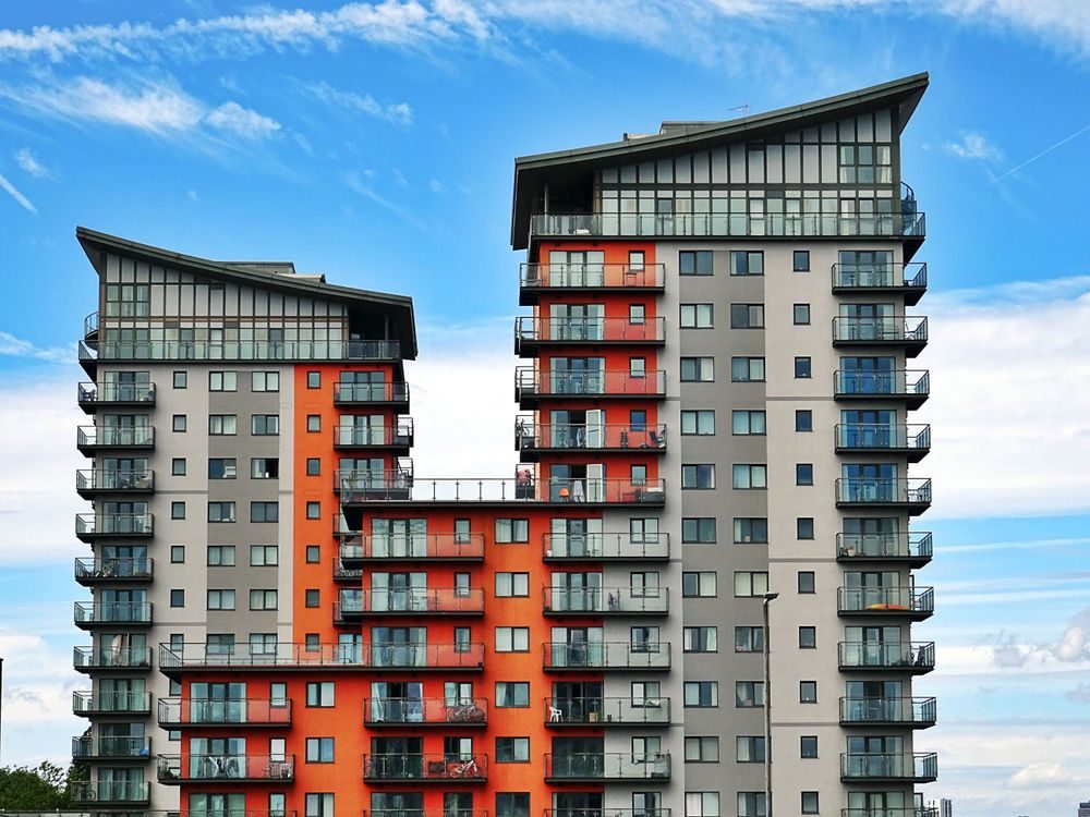 Modern residential towers under a blue sky, representing registered accommodation requirements for Serbian single permit renewals