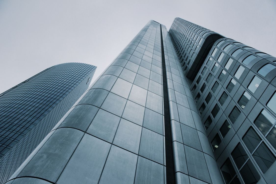 Office towers photographed from below against a clear sky