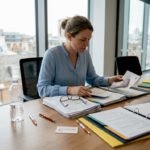 HR manager reviewing relocation documents in office