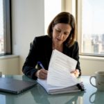 HR manager reviews employee assignment documents