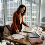 HR manager sorts papers in bright corner office